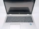 a laptop that is open on a white surface