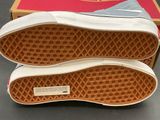 vans off the wall slip - on sneakers in a box on a table