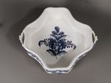a blue and white bowl with a flower design on it