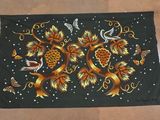 an image of a black table cloth with a design of birds and flowers