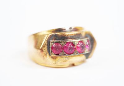 an image of a gold ring with pink stones on it