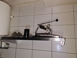 a bathroom with a white toilet and a black and white sink