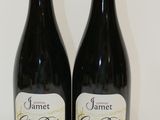 two bottles of wine sitting on a table next to each other