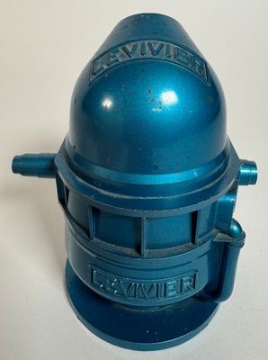 an image of a small blue metal object on a white surface