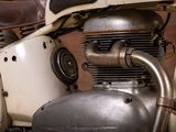 a close up view of a motorcycle engine and exhaust pipe