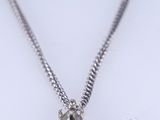 a close up of a necklace and a pair of earrings on a white surface