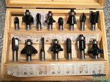 many different types of router bits in a wooden box