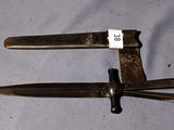 two knives that are sitting on a table next to each other