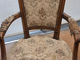 an old chair with a floral upholstered seat