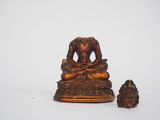 a statue of a person sitting in a lotus position
