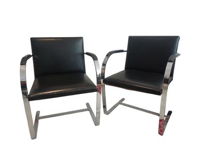two black leather chairs with chrome legs and a black leather seat