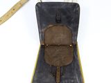 an old leather bag with a strap hanging from it ' s side