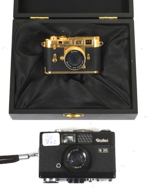 a black box with a gold camera inside of it