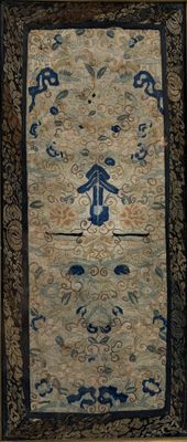 an image of a blue and beige oriental rug with a man on a horse