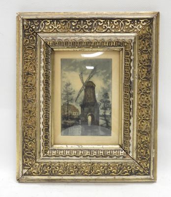 an old picture of a windmill in a gold frame on a white wall