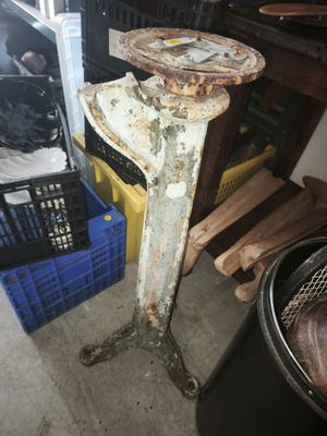 a rusted metal table with a basket on top of it