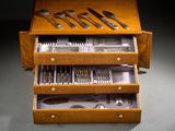 a wooden box with silverware in it on a table