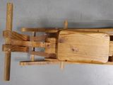 a wooden sled that is attached to a wall