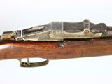 an old rifle with a wooden barrel and a metal handle