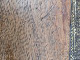 a close up of a wooden table with writing on it