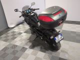 a motorcycle that is parked on a checkered floor