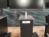 three computer monitors and a keyboard on a table