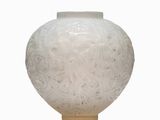 a white vase that has a lot of white stuff in it