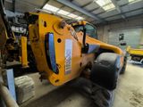 a large yellow machine that is parked in a garage