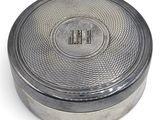 an image of a silver box with a monogram on the lid