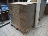 a stack of cardboard sitting on a pallet in a warehouse