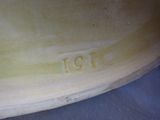 a close up of a vase with a number on it