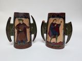 pair of art decoupholation vases with figures on them