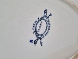 a blue and white plate with a picture of a turtle on it