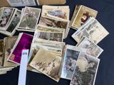 a lot of old postcards on a table
