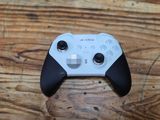 a close up of a game controller on a wooden table