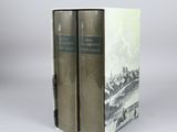two books sitting on top of each other in front of a gray background
