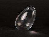 a clear glass object sitting on a black surface
