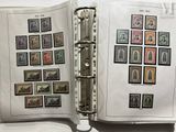 an open book with stamps on it on a table