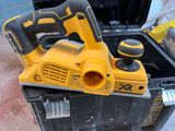 a yellow corded planer sitting on top of a black box
