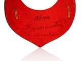 an image of a red heart shaped object with writing on it