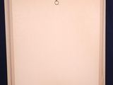 a wooden easel with a blank canvas on it against a blue background