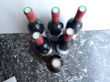 several bottles of wine are lined up on a counter top