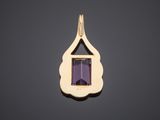 a gold pendant with an amethe stone in the center