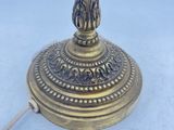 an antique brass table lamp with a blue glass shade on it