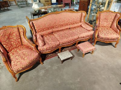 three couches and a chair in a room