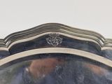 a large silver plate with a design on it