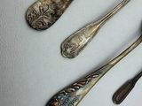 five spoons and two spoons sitting on a table