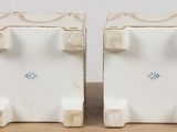 pair of white ceramic bookends with blue and white designs