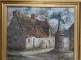 an oil painting of a village scene in a gold frame on a wall