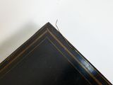 a small bird sitting on top of a black table